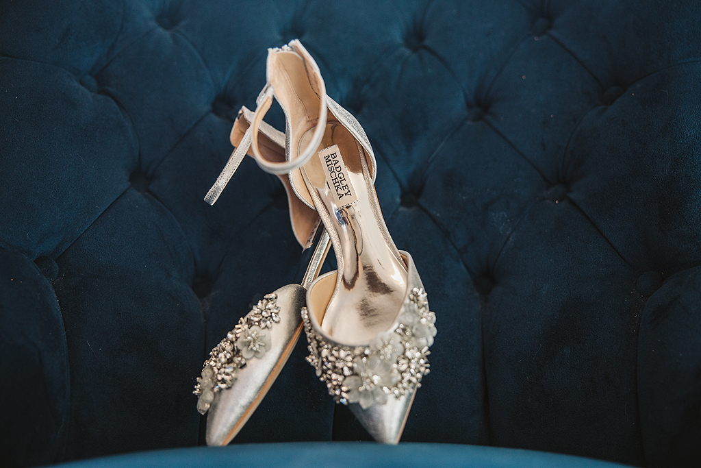 bride's badgley mischka shoes on blue chair