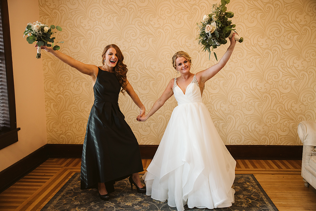 bride and bridesmaid laughing in The Haight in Elgin Illinois