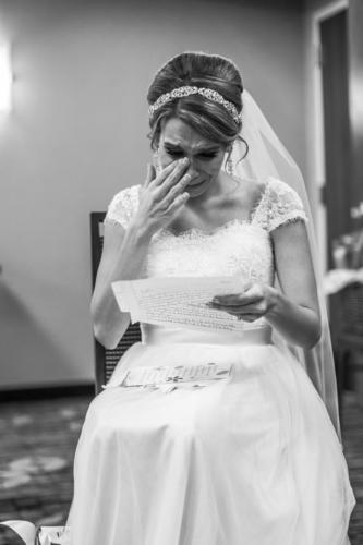bride crying while reading letter from groom 