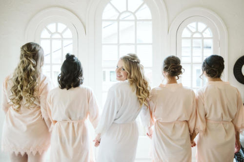 bride with her bridesmaids getting ready for a wedding